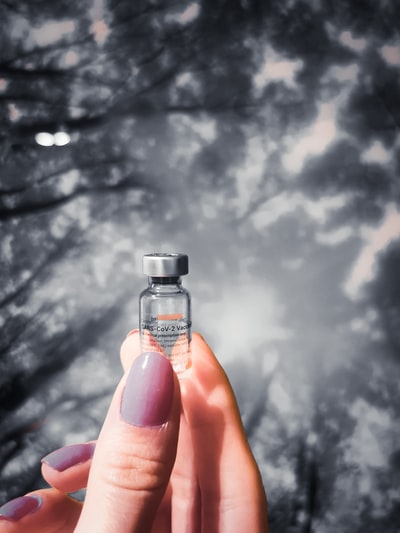 Holding a transparent glass bottle
